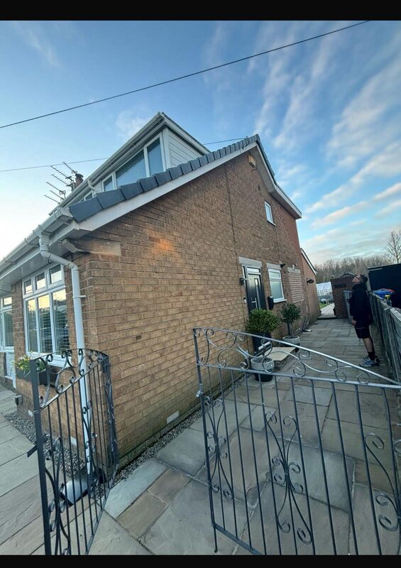 Brick dormer bungalow with wrought iron gate and stone patio in Blackpool