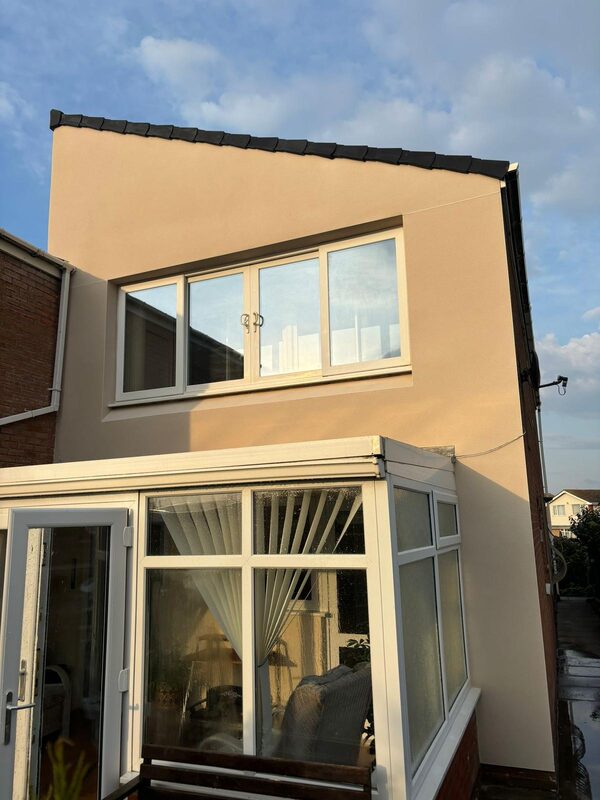 Smooth exterior render finish on upper storey extension above conservatory