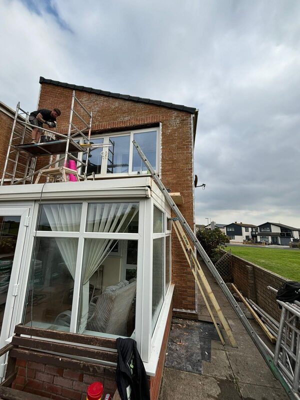 Exterior rendering work in progress with scaffolding on residential property
