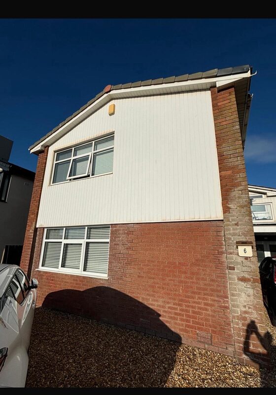 Detached house exterior before renovation with brick and cladding in Blackpool